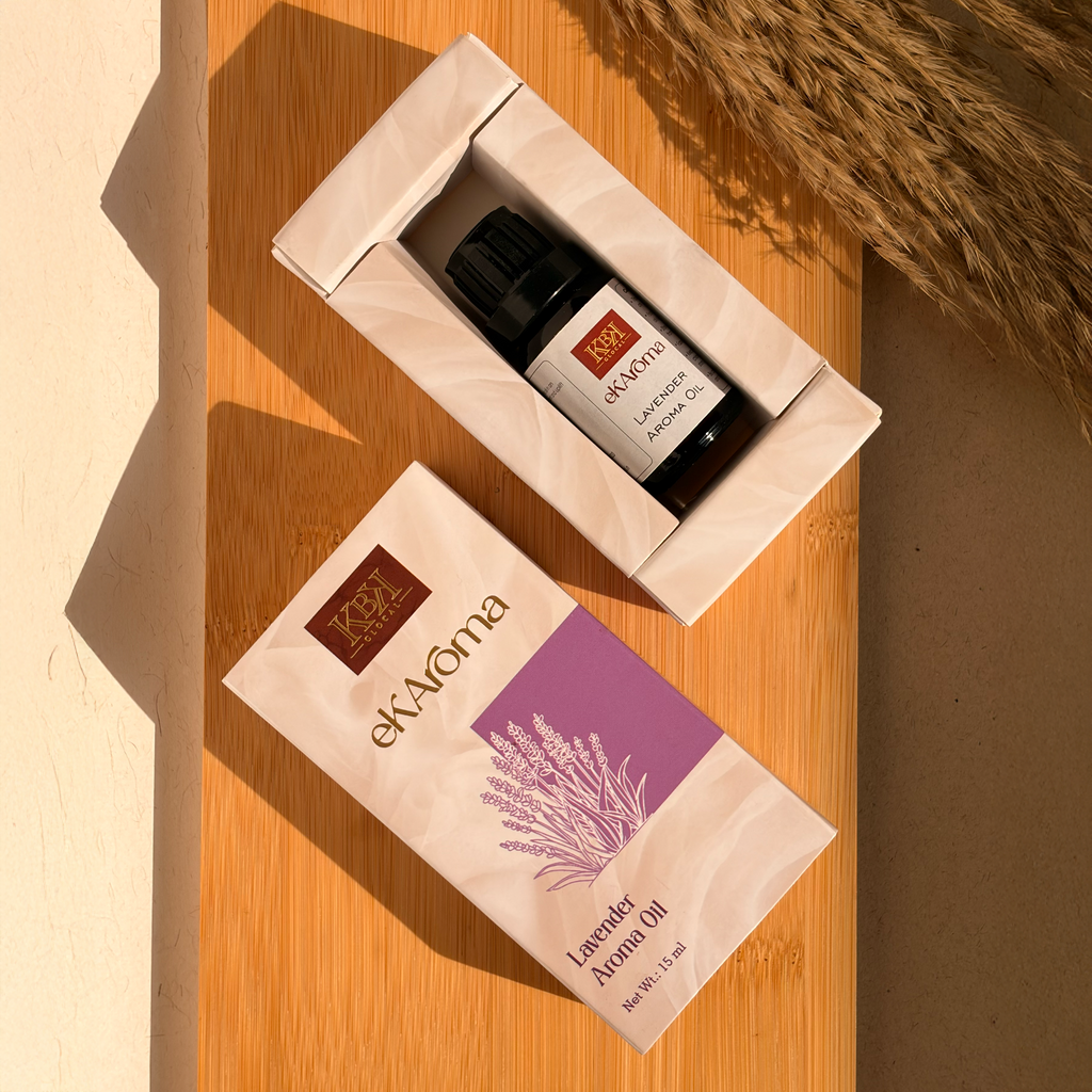 ekAroma lavender aroma oil packaging on a wooden surface with a decorative vase in the background.
