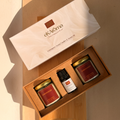 Gift set with candles and essential oils from ekAroma on a wooden surface.
